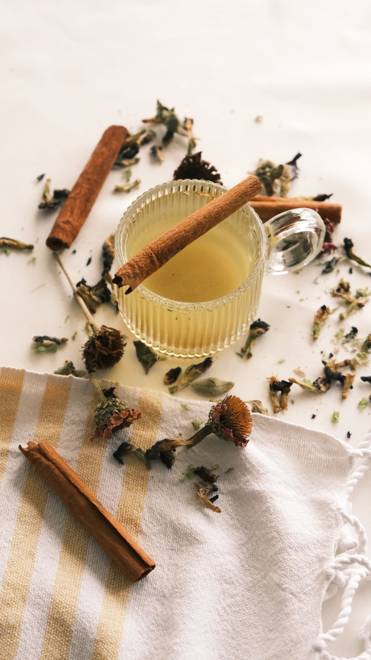 Warm herbal tea with cinnamon sticks on a rustic table setting.
